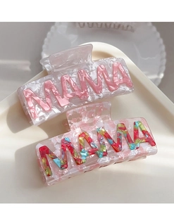Detailed view of acetate hair claws featuring MAMA letters with pearlescent textures