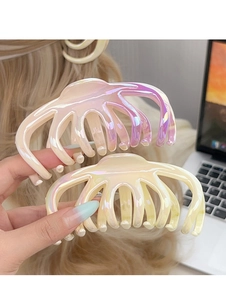 Close-up of large octopus hair claws with pearlescent gradient finish and multi-tooth design