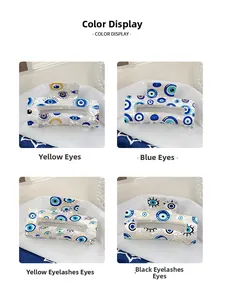 Detailansicht von vier PVC-Haarklammern mit bösem Auge in Gelb, Blau und Wimpern