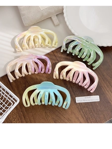 Detailed view of large gradient iridescent hair claws in five vibrant pearlescent colors