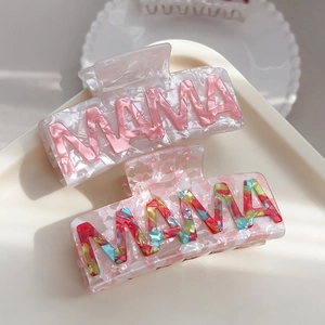 Floral acetate hair claws with MAMA lettering in pink and rainbow colors on white