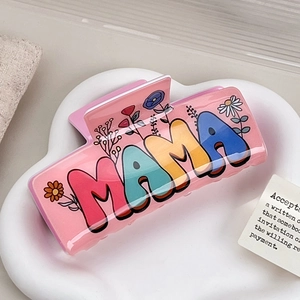 Pink acrylic MAMA hair claw clip with floral patterns and polished finish