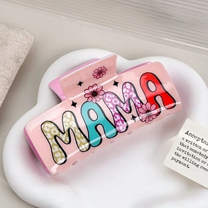 Pink acrylic MAMA hair claw clip with colorful leopard print letters and floral patterns