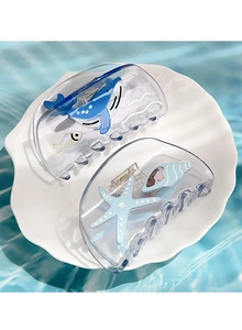 Gros plan de pinces à cheveux sur le thème marin avec motifs baleine et étoile de mer
