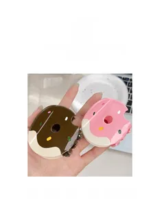 Detailed view of donut-shaped hair claws in chocolate brown and strawberry pink acrylic