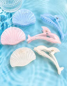 Detailed view of translucent jellyfish and dolphin hair clips in pastel summer colors