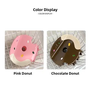 Detail view of pink and chocolate doughnut hair claws with colorful sprinkles and gloss finish