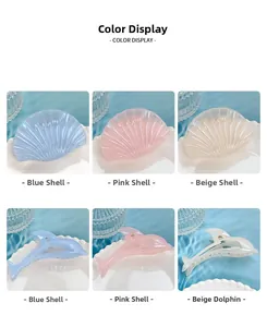 Detail view of shell and dolphin shaped hair claws in blue, pink and beige jelly colors