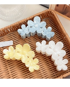 Three gradient floral claw clips in blue, yellow, and cream white with marble texture