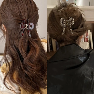 Elegant bow-shaped acetate hair claw clips in red tortoiseshell and leopard print patterns