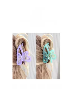 Detail of lavender and mint green hollow butterfly hair claws in acetate finish