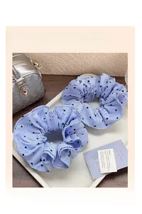 Detail of blue striped scrunchies with black heart patterns in a stylish setting