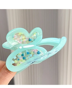 Detail of mint green acetate butterfly hair claw with colorful glitter sequins inlay
