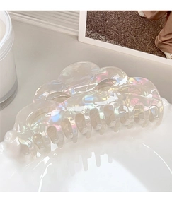 Detail of elegant large pearlescent white hair claw clip with iridescent finish