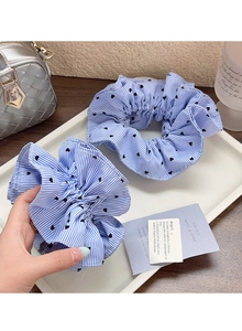 Detail of blue and white striped scrunchies with black heart patterns and high elasticity