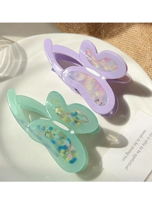 Detail of hollow butterfly hair claw with aurora glitter finish and spring clip