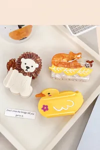 Three acetate hair claws featuring cute lion, fox, and yellow duck cartoon characters