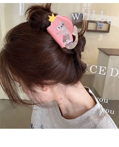 Pink mermaid hair claw clip with pearlescent sequins worn by a model in a side view