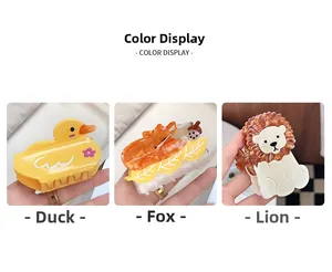 Detailed view of cartoon lion, fox, and duck acetate hair claws with vibrant colors