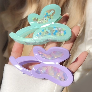 Elegant butterfly hair claws in mint green and lilac with pearlescent glitter finish
