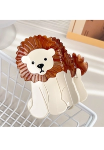 Detailed shot of a lion-shaped acetate hair claw clip with cream and amber finish