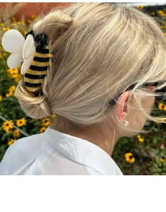 Gros plan d'une pince à cheveux abeille réaliste avec des rayures jaunes et noires