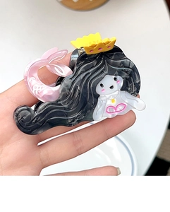 Detail of mermaid hair claw clip made of marble texture acetate in hand