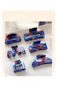 Detail view of 6-piece blue fireworks acetate hair claw clips in various geometric shapes