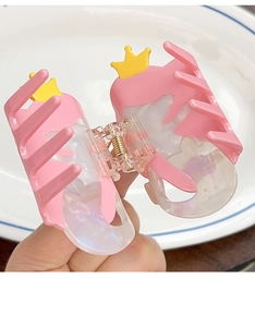 Detail shot of a pink mermaid crown hair claw clip with transparent marbled texture