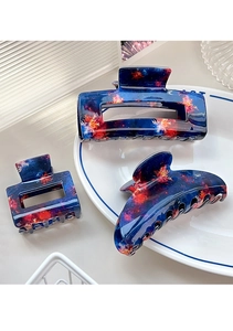 Close-up of blue nebula pattern acetate hair claw clips in square and crescent shapes