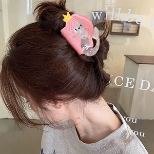 Sweet pink hair mermaid hair claw clip worn on a bun for a casual aesthetic look