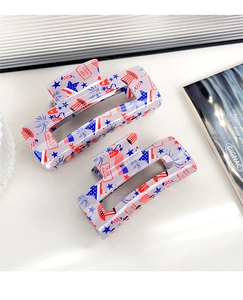 Close-up of rectangular hair claw clips with American flag stars and stripes design
