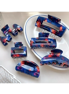 Detailed close-up of blue acetic acid hair clips in various shapes on a white tray