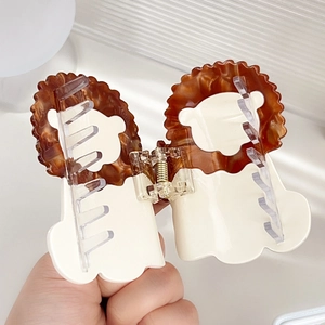 Cartoon lion-shaped acetate hair claw clip with brown mane and cream white body finish