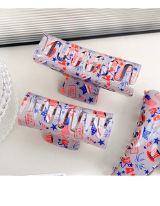 Detail view of acetate star hair claws with American flag patterns and USA motifs