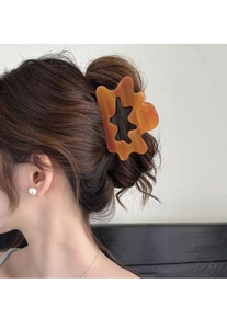 Detail of French cloud hair claw in dark orange amber texture on model's hair
