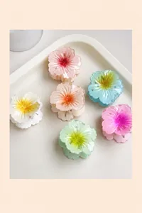 Detailed set of six colorful resin plumeria hair claw clips in vibrant macaron shades