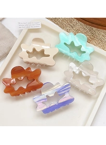 Detail showing five assorted pastel marble hollow cloud hair claws on a white tray