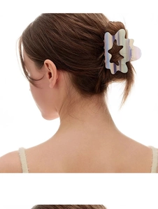 Close-up of holographic cloud hair claw clip with star cutout on model back of head