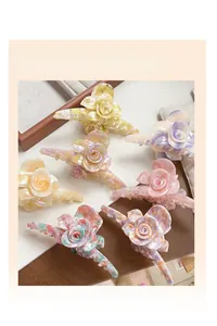 Detailed macro view of assorted acetate rose flower hair claws in multiple colors