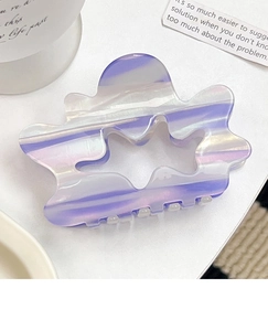 Close-up of a marbled purple acetate cloud-shaped hair claw clip with cutout design