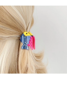 Detailed view of fish-shaped acetate hair claw clip with blue and pink gradient design