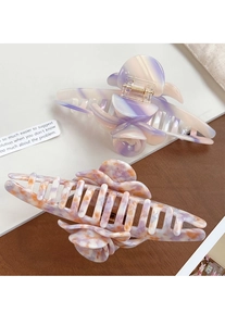 Detail view of large acetate flower claw clips with marble and floral patterns