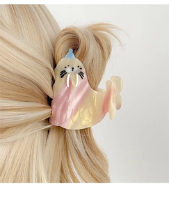 Detail of walrus hair claw clip with pink marble finish on blonde hair