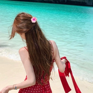 Pink Plumeria flower hair claw clip for beach vacation styling shown on long hair