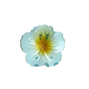 Tropical blue plumeria hair claw clip with yellow gradient for seaside vacation styling