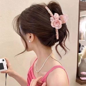 Pink acetate 3D rose flower hair claw clip shown on model for an elegant hairstyle look