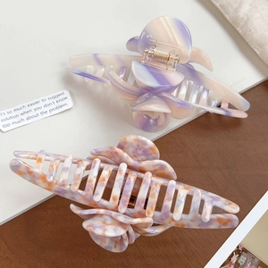 Large acetate flower hair claws in purple and orange marble patterns with gold spring