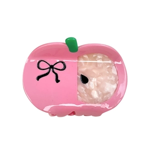 Pince à cheveux pomme rose en acétate avec petit nœud noir et détail de feuille verte