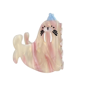 Ocean themed seal claw clip made of pink marble acetate with a small blue party hat